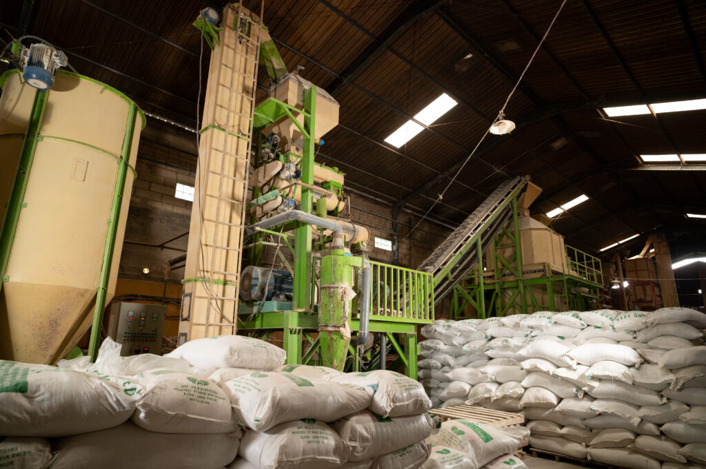 Sacks of poultry feed and machine to process it